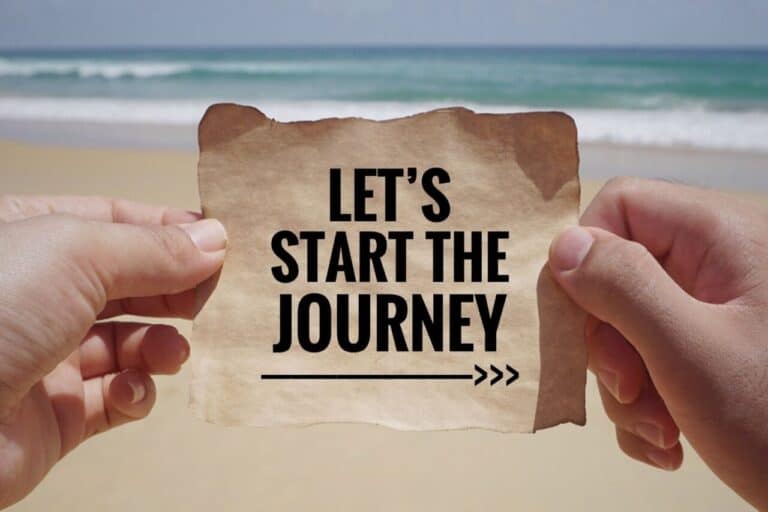 hands holding a note that says Let's start the journey